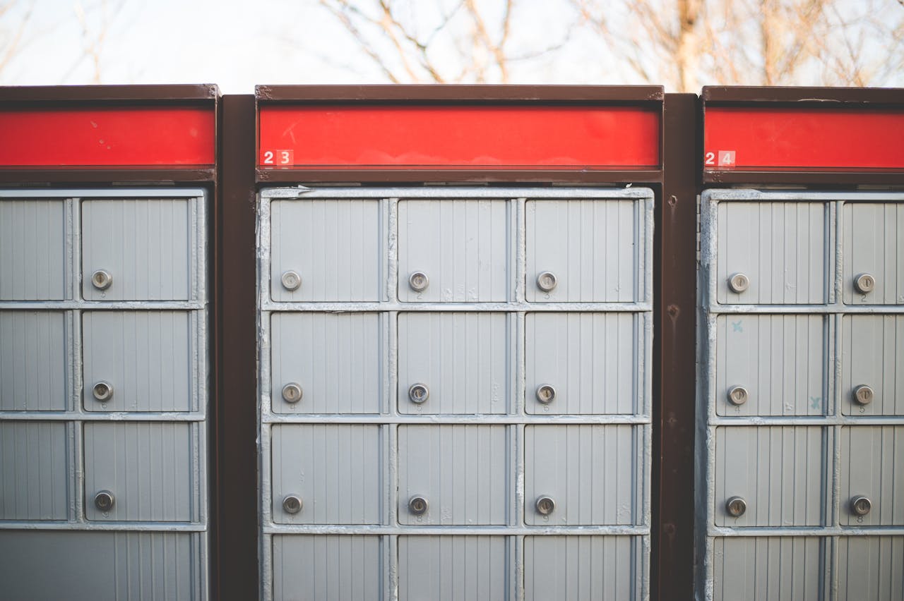 home-hero-bg Image of secure outdoor community mailboxes with individual lockers in a row.